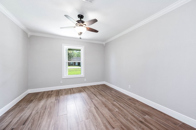 empty room with ceiling fan, crown molding, and hardwood / wood-style flooring