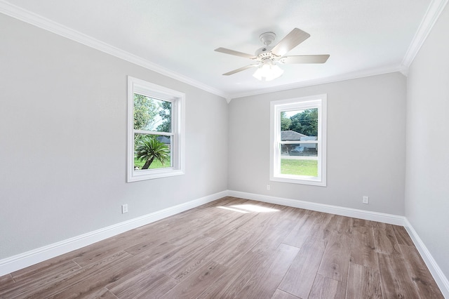 spare room with ornamental molding, hardwood / wood-style flooring, and ceiling fan