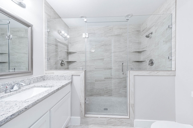 bathroom with vanity, toilet, and walk in shower