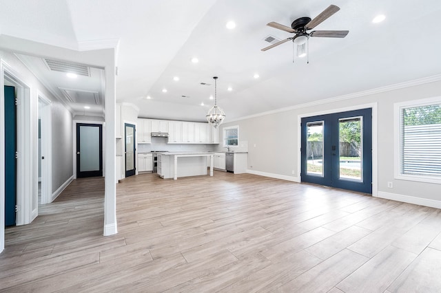 unfurnished living room featuring light hardwood / wood-style flooring, ceiling fan with notable chandelier, french doors, and crown molding