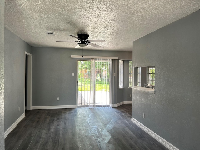 spare room with ceiling fan and dark wood-type flooring