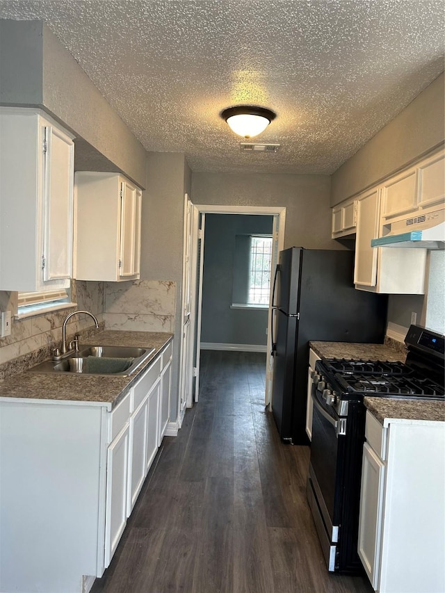 kitchen with range with gas cooktop, backsplash, dark hardwood / wood-style floors, and white cabinetry