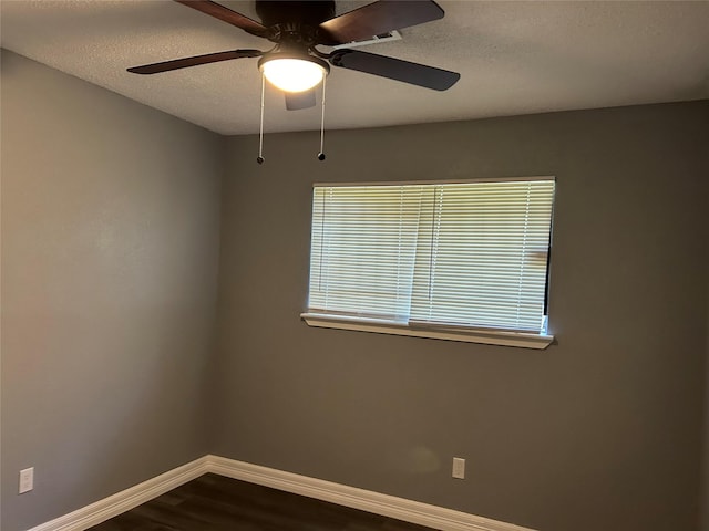 unfurnished room with ceiling fan, wood-type flooring, and a textured ceiling