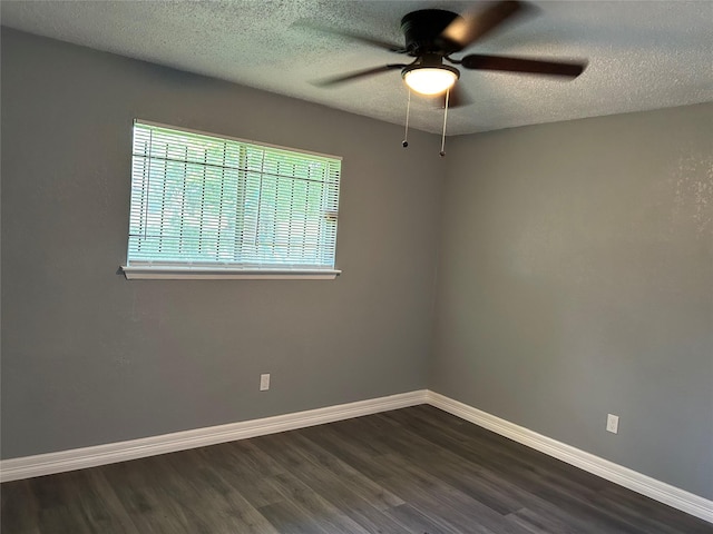 unfurnished room featuring ceiling fan, dark wood-type flooring, and a textured ceiling