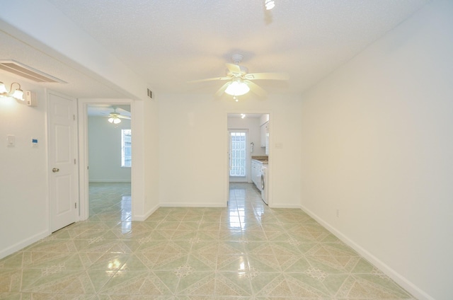 spare room featuring ceiling fan and a textured ceiling