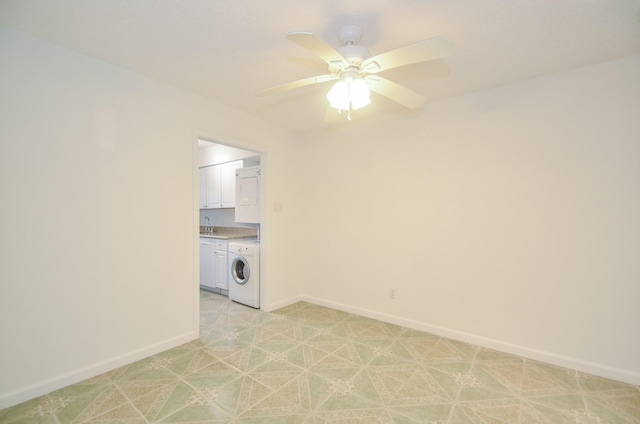 clothes washing area featuring washer / clothes dryer, ceiling fan, sink, and cabinets