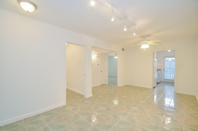 spare room with ceiling fan and a textured ceiling