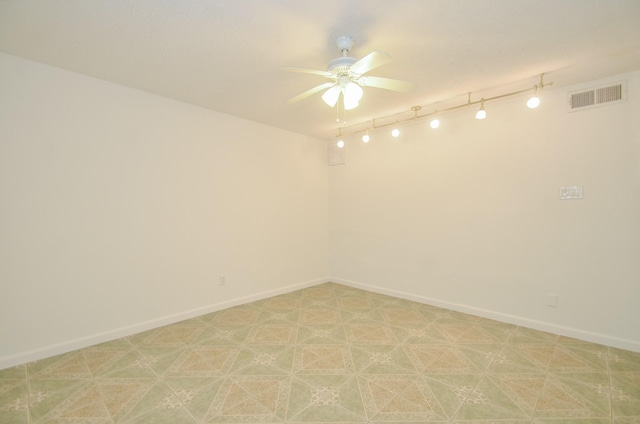 unfurnished room featuring ceiling fan and track lighting