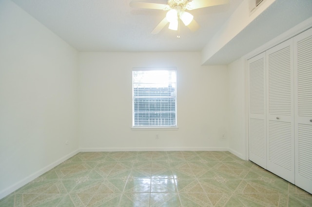 unfurnished bedroom featuring a closet and ceiling fan