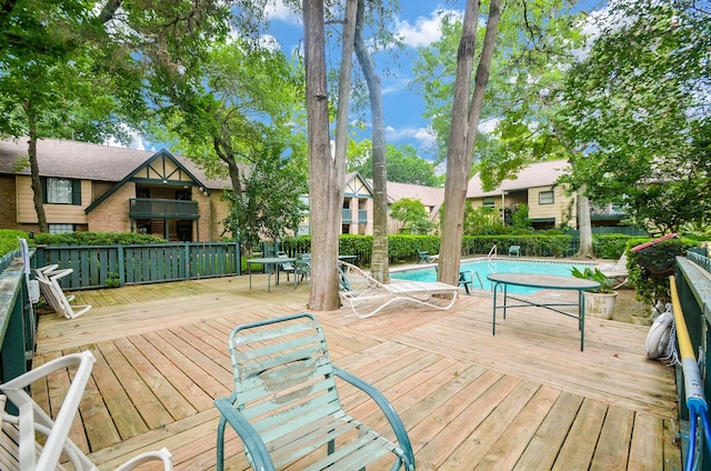 wooden terrace featuring a fenced in pool