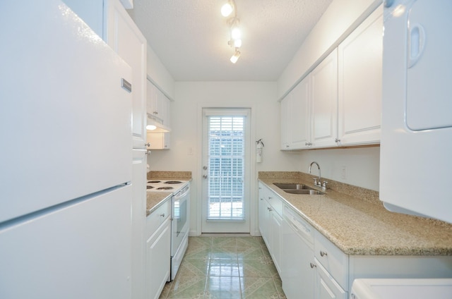 kitchen with white cabinets, white appliances, sink, and a textured ceiling