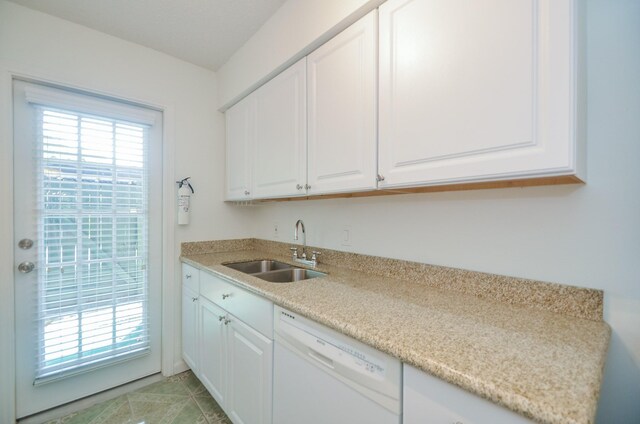 kitchen featuring dishwasher, sink, white cabinets, and light tile patterned floors