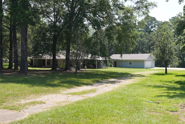 view of yard with driveway and an attached garage