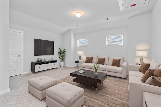 living room featuring carpet flooring and vaulted ceiling