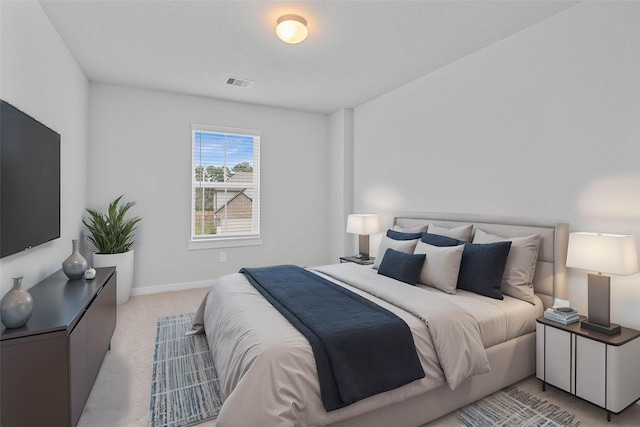 bedroom with light colored carpet