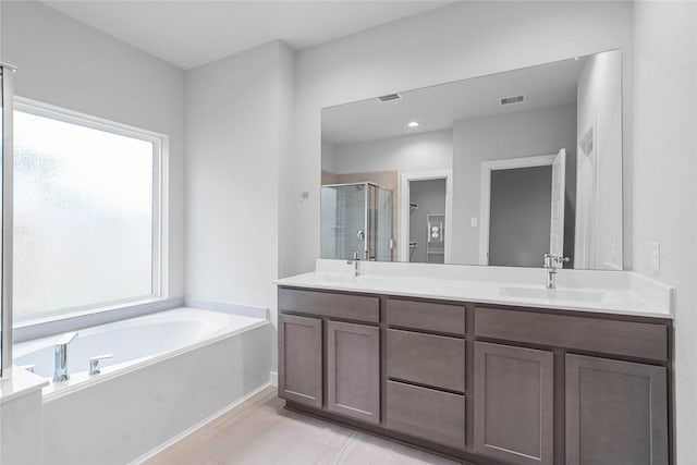 bathroom featuring shower with separate bathtub and vanity