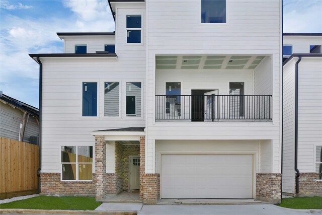 view of front facade with a balcony and a garage