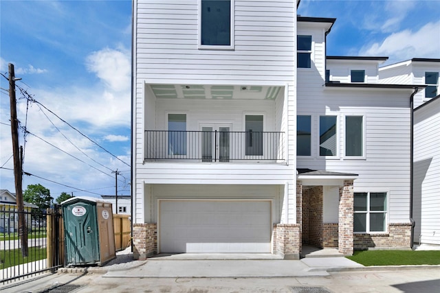 view of front of property with a garage and a balcony