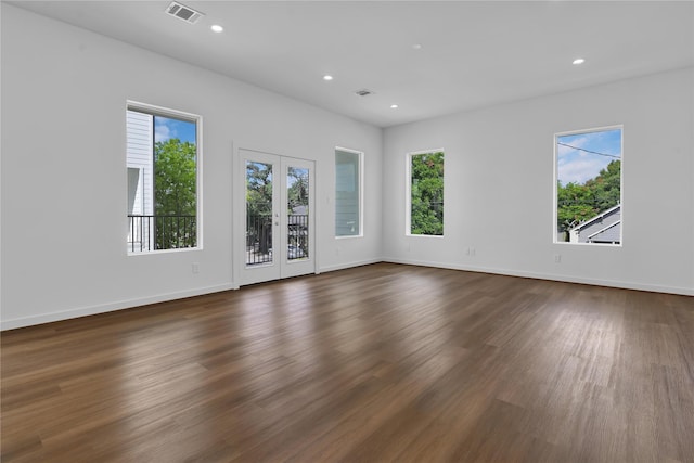 spare room featuring french doors and dark hardwood / wood-style floors