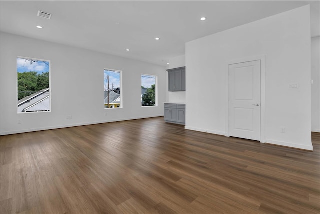 unfurnished living room with dark hardwood / wood-style flooring