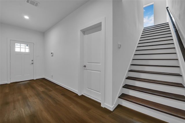 foyer entrance with dark wood-type flooring and plenty of natural light