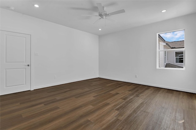 spare room with ceiling fan and dark hardwood / wood-style flooring