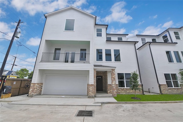 view of front of house with a garage, a balcony, and central AC