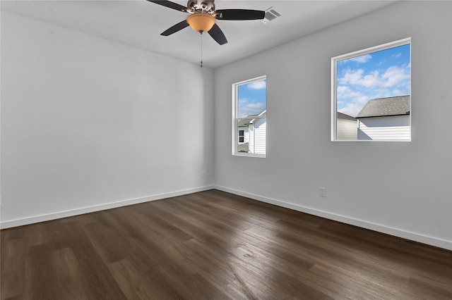 unfurnished room featuring dark wood-type flooring and ceiling fan