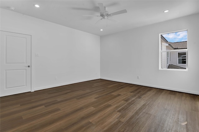 empty room with dark hardwood / wood-style floors and ceiling fan