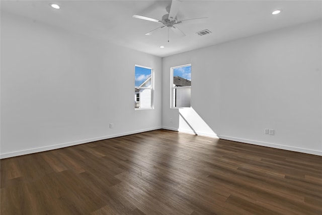 unfurnished room with dark wood-type flooring and ceiling fan