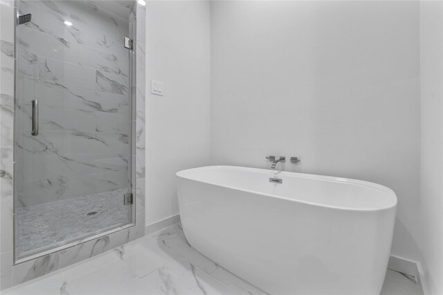 bathroom featuring tile flooring and separate shower and tub