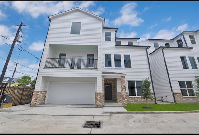 view of front of home with a garage and a balcony