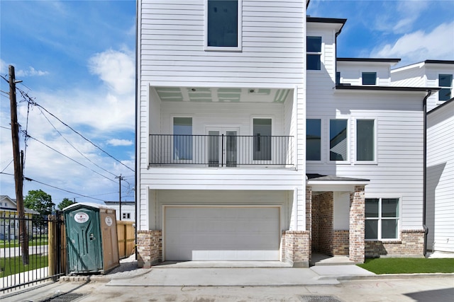 view of front of home with a garage and a balcony