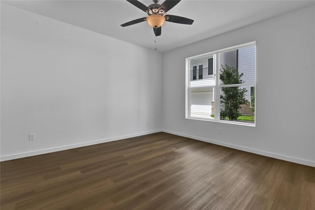 unfurnished room with ceiling fan and dark hardwood / wood-style flooring