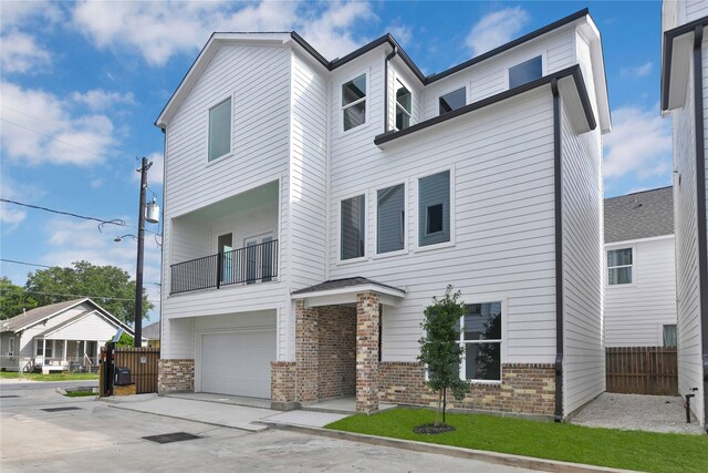 view of front of property with a garage and a balcony