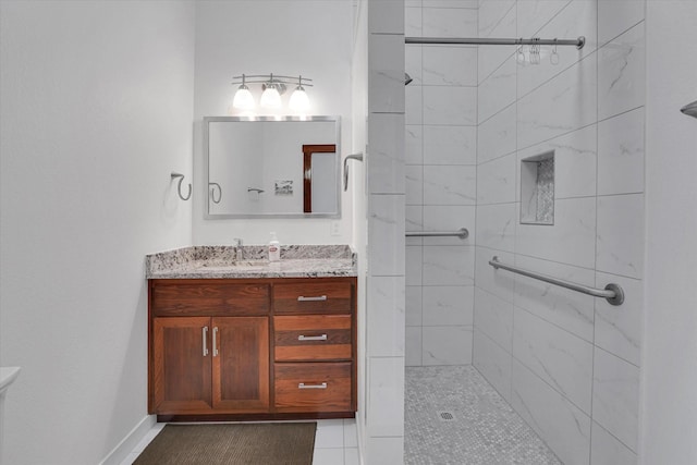 bathroom featuring vanity and tiled shower