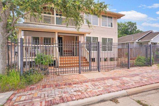 view of front of property featuring a balcony