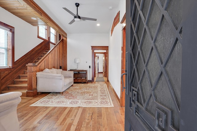 living room featuring light hardwood / wood-style flooring and ceiling fan