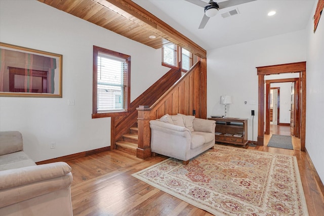 living room featuring ceiling fan, wooden ceiling, and light hardwood / wood-style flooring