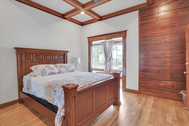 bedroom featuring beam ceiling, light hardwood / wood-style flooring, and coffered ceiling