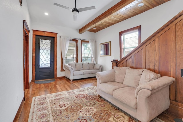 living room with beam ceiling, ceiling fan, wood ceiling, and light wood-type flooring