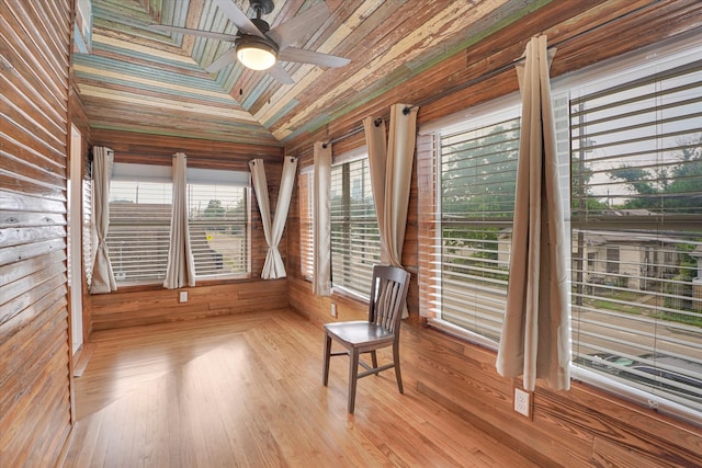 unfurnished sunroom with vaulted ceiling, ceiling fan, and wooden ceiling