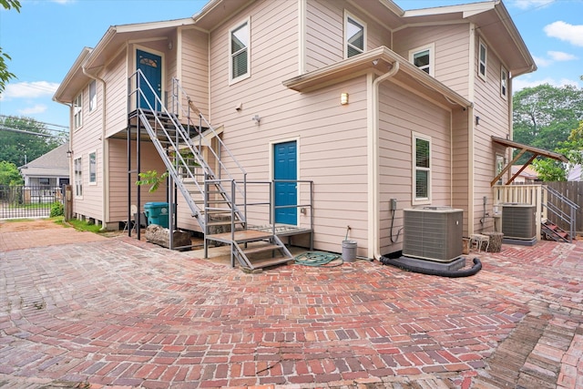 back of property featuring cooling unit and a patio area