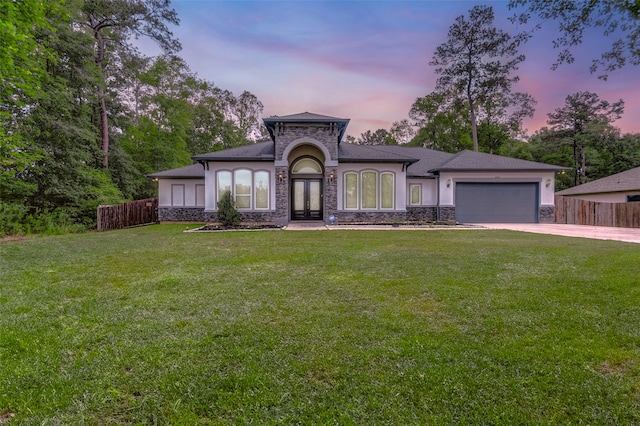 view of front of property featuring a yard and a garage