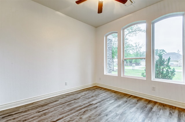 spare room with hardwood / wood-style flooring and ceiling fan