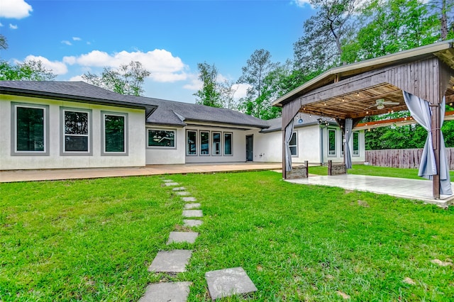 back of house with a patio area and a yard