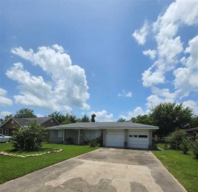 ranch-style home with a garage and a front lawn