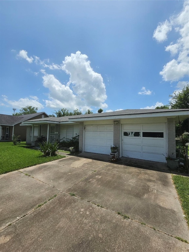 view of front of home with a garage, a front lawn, and brick siding