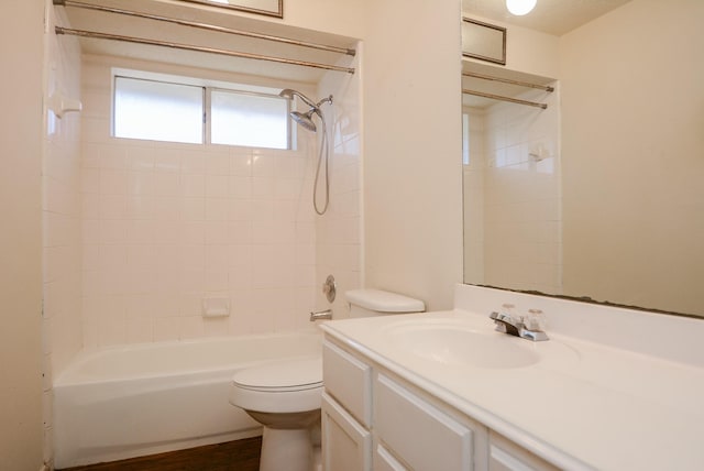 bathroom featuring wood finished floors, toilet, bathtub / shower combination, and vanity