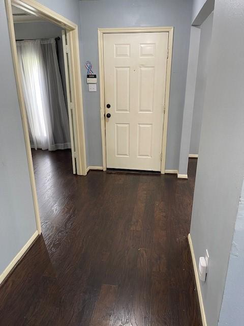 hall with baseboards and dark wood-style flooring